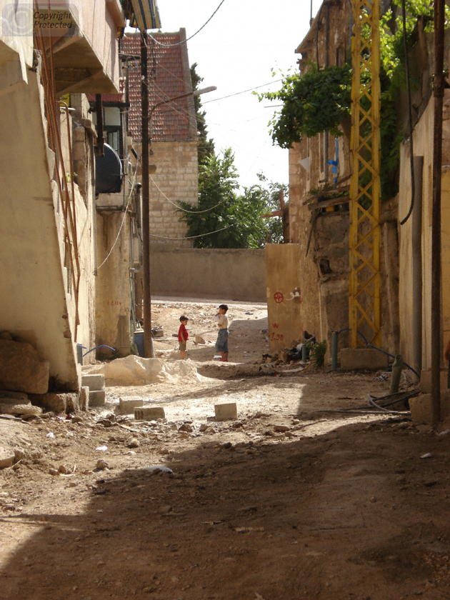 Two boys playing in a street near the Roman Ruins in Baalbek